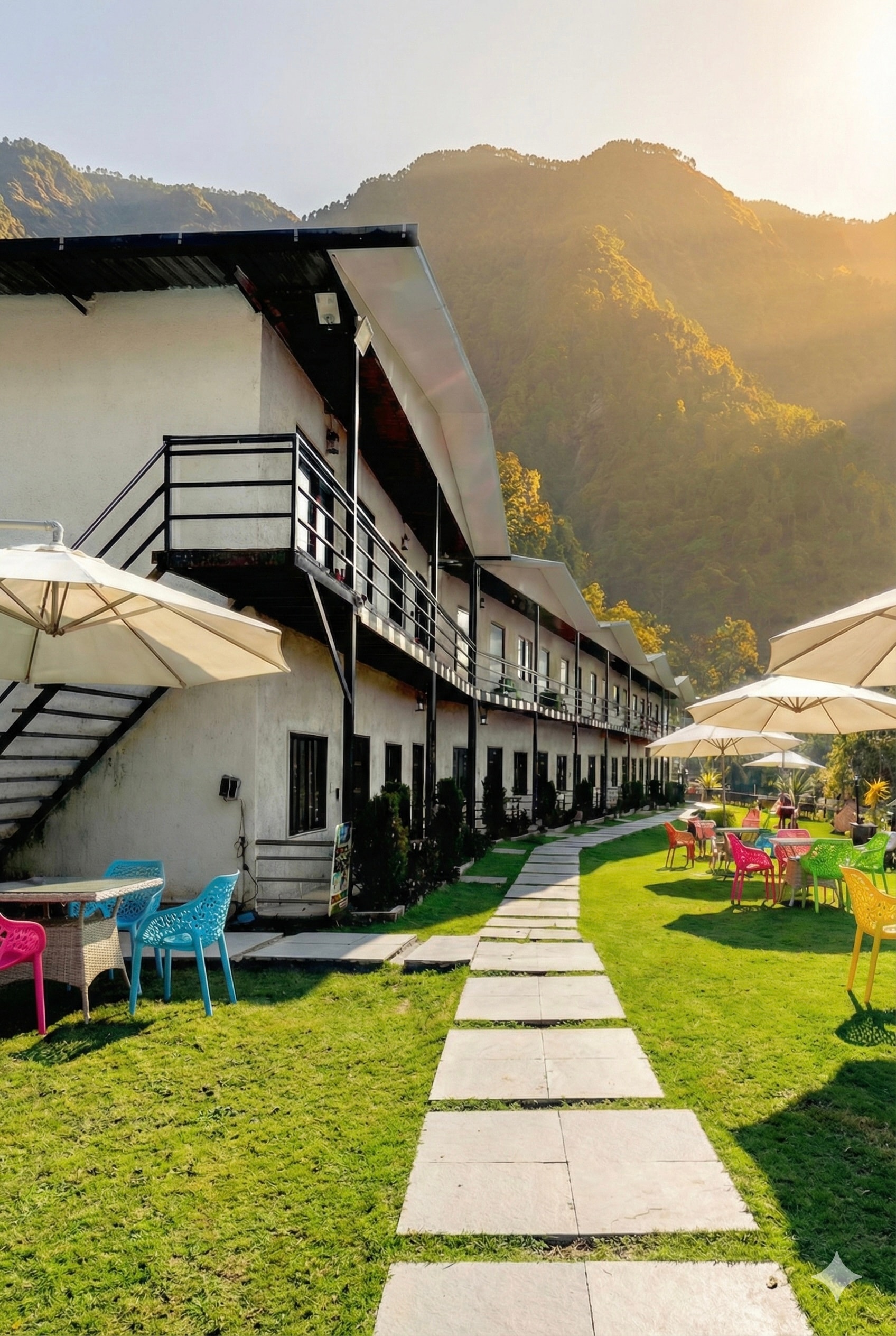 KIA RESORTS property exterior with mountain backdrop and outdoor seating