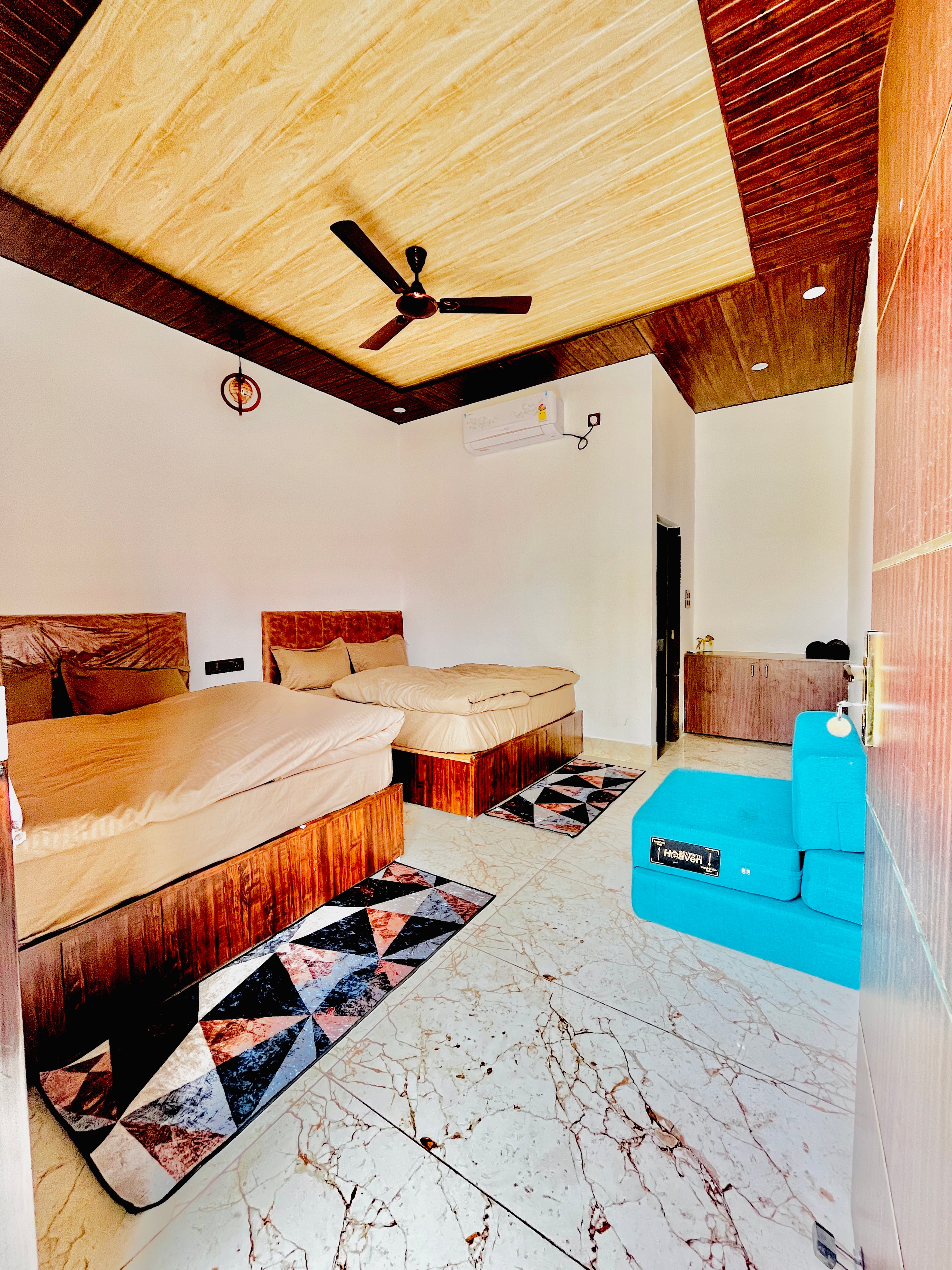 KIA RESORTS family room interior with wooden ceiling and marble floors